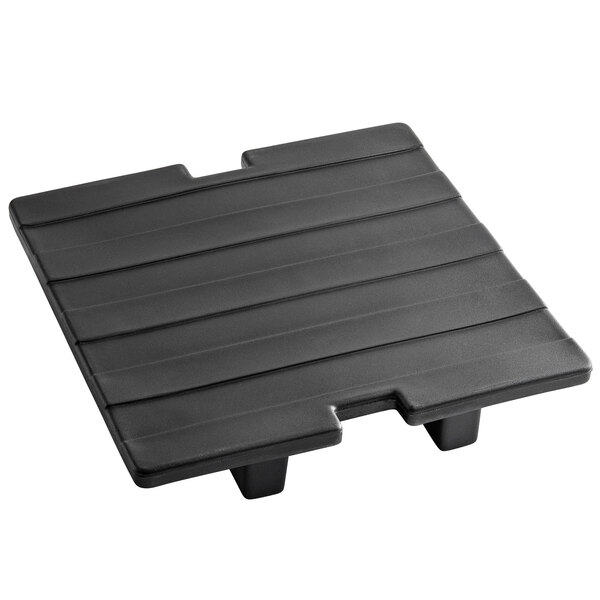 A black plastic shelf for Carlisle Cateraide Ice Caddies on a table.