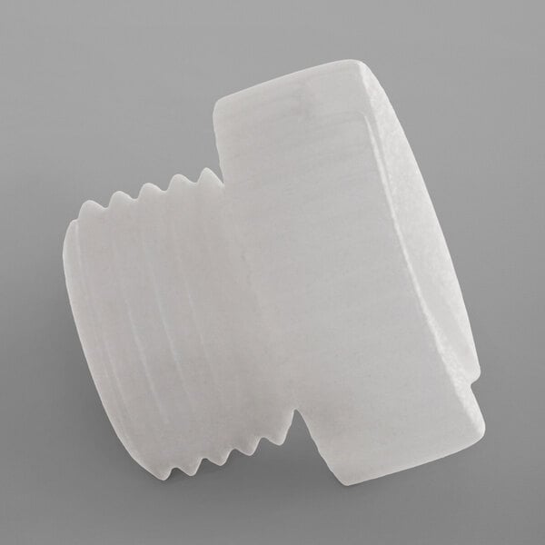 A white plastic plug for a Noble Warewashing rinse arm.