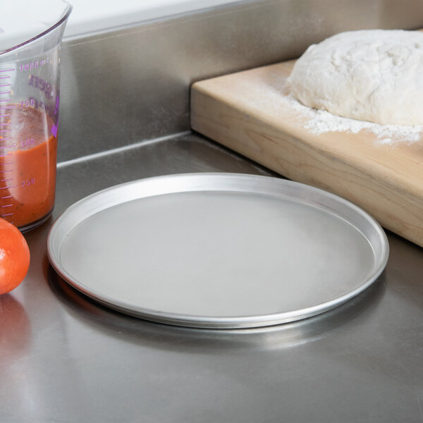 An American Metalcraft Tapered Deep Dish Pizza Pan on a counter.