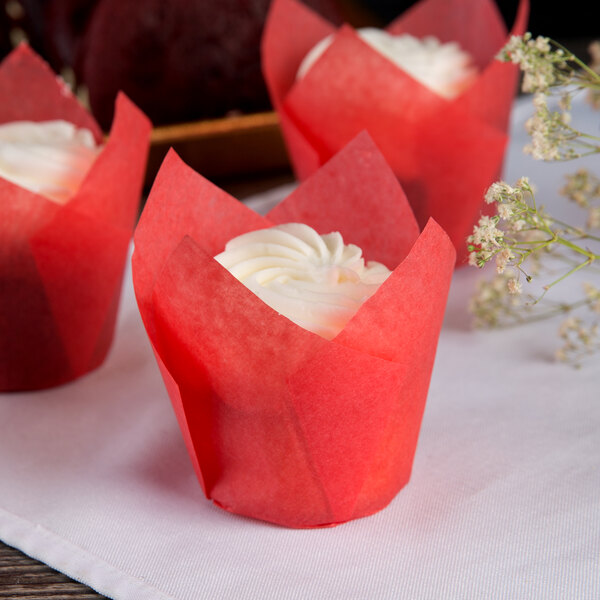 Red velvet cupcakes with cream cheese frosting in Hoffmaster red tulip baking cups.