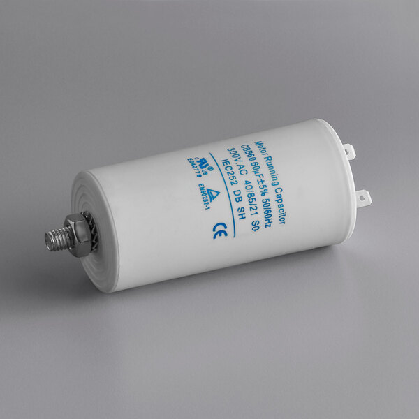 A white tube with blue text: "AvaMix Motor Capacitor"