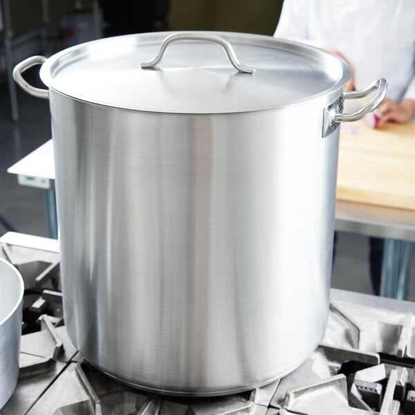 A Vollrath stainless steel stock pot on a stove.