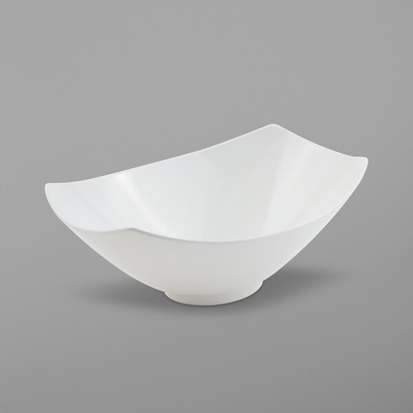 A white Bon Chef Gondola bowl with a curved edge on a gray background.