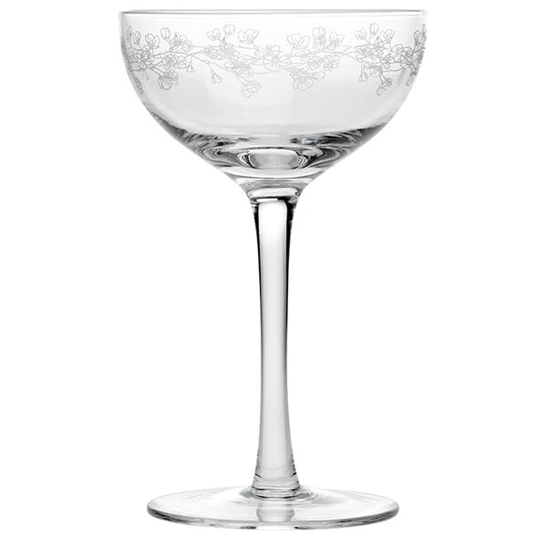 An Arcoroc clear wine glass with a stem and a floral design.