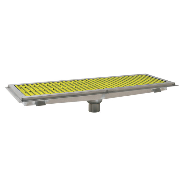 A metal surface with yellow and silver metal grating over a floor trough.