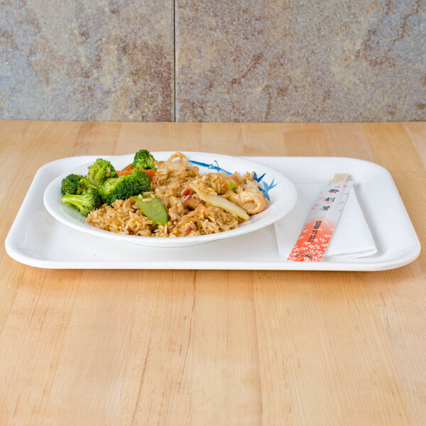 A blue bamboo Thunder Group melamine tray with a plate of rice and vegetables on it.