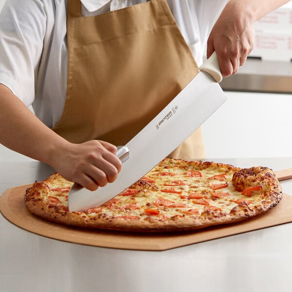 A person using a Dexter-Russell Sani-Safe pizza knife with a white handle to cut a pizza.