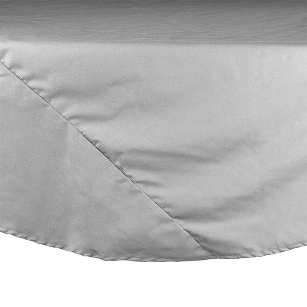 A white round tablecloth with a gray hem.