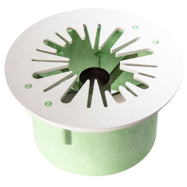 A green and white circular blade cup with a hole in the center.
