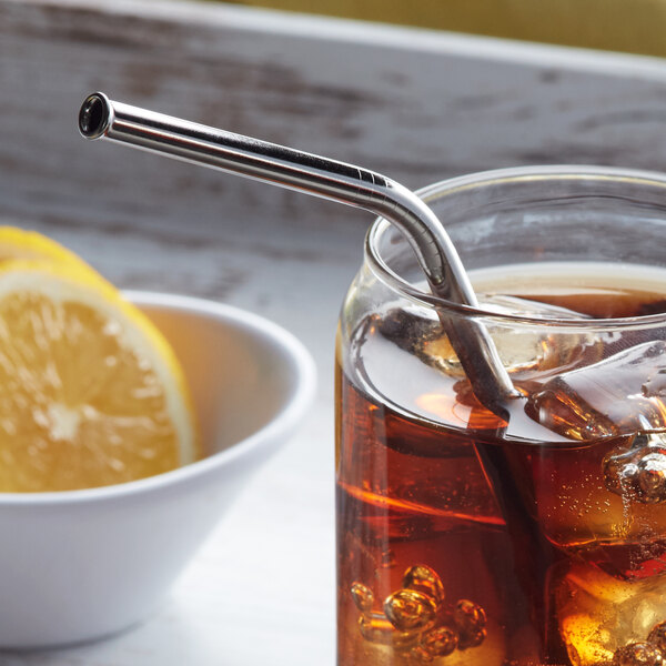 A glass of iced tea with a Barfly stainless steel straw and a lemon slice.