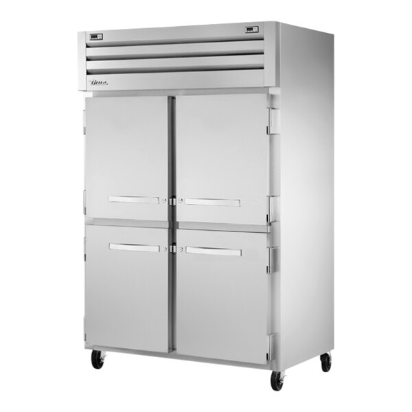 A True commercial combination refrigerator and freezer with four half doors.