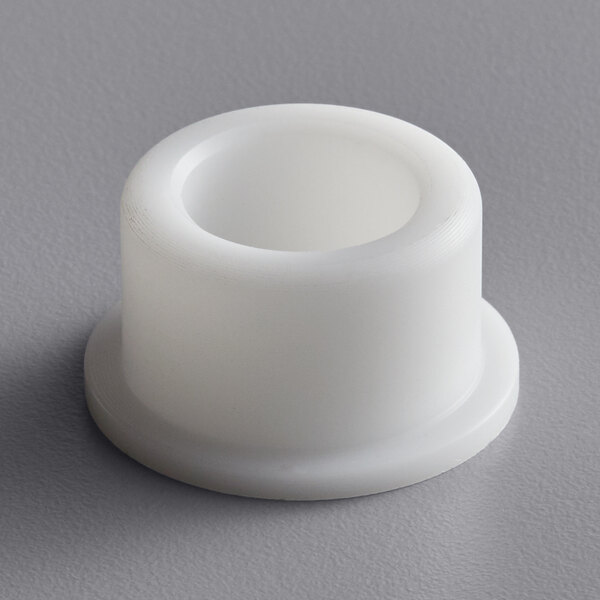 A white plastic Sunkist Delrin bearing.