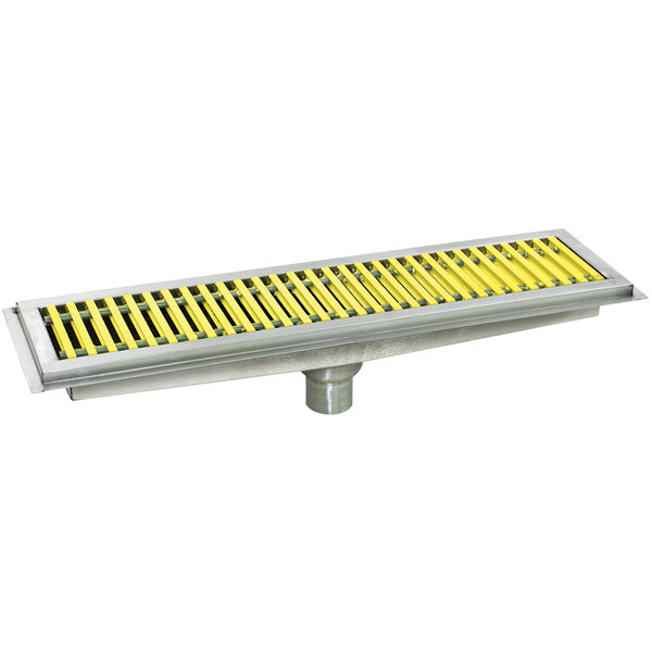 A stainless steel Eagle Group floor trough with yellow fiberglass grating over it.