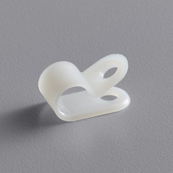 A white plastic Sunkist cord strain relief clip.