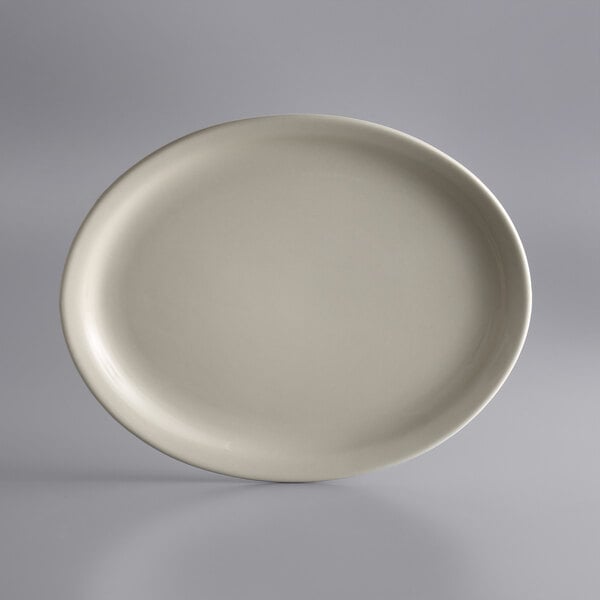 A white Libbey narrow rim oval platter on a gray surface.