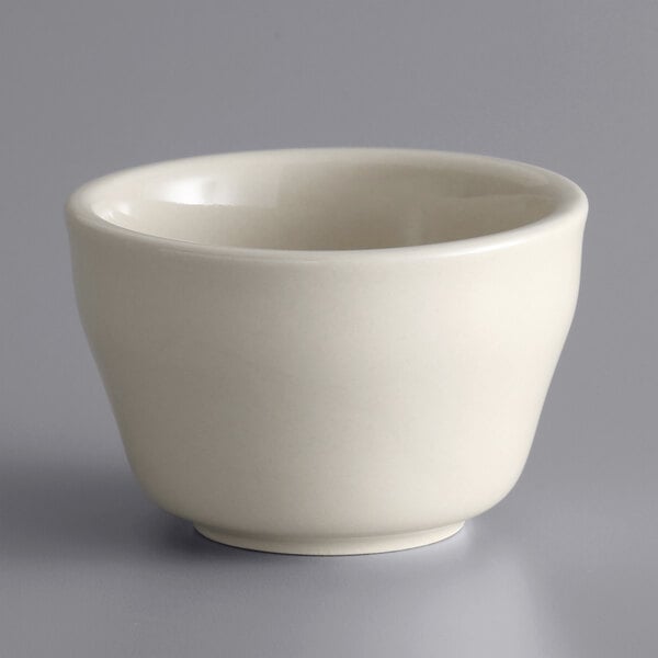 A close up of a Libbey Ultima Cream White stoneware bouillon bowl.