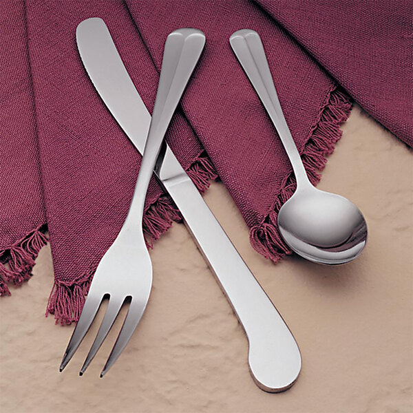 A Libbey medium weight stainless steel teaspoon on a napkin.