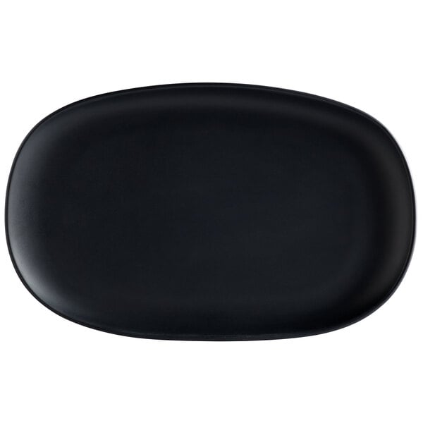 A dark gray oval plate with a matte finish and irregular edges.