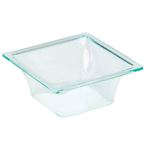 A Delfin green glass square insert with a clear lid in a salad bar counter.