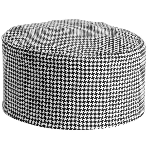 A black and white houndstooth Mercer Culinary chef hat.