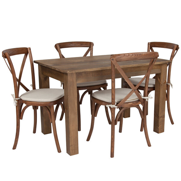 A Flash Furniture solid pine folding farm table with four wooden cross back chairs with white cushions.