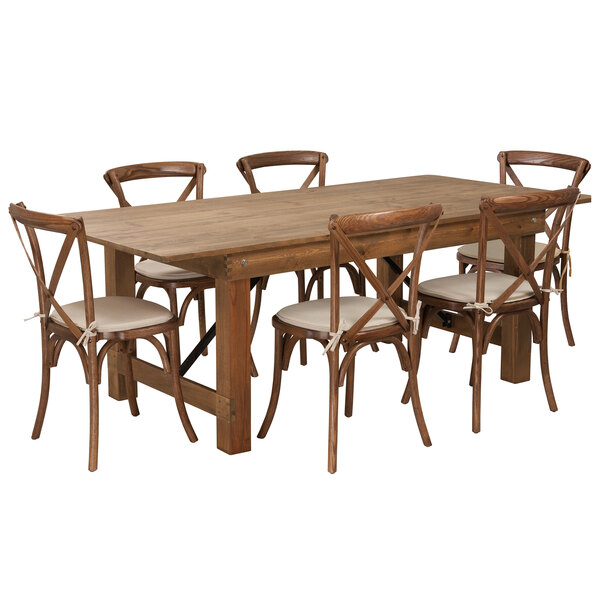 A Flash Furniture wooden farm table with chairs with white cushioned seats.