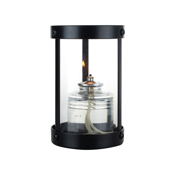 A Sterno black glass votive candle holder with a flame inside.