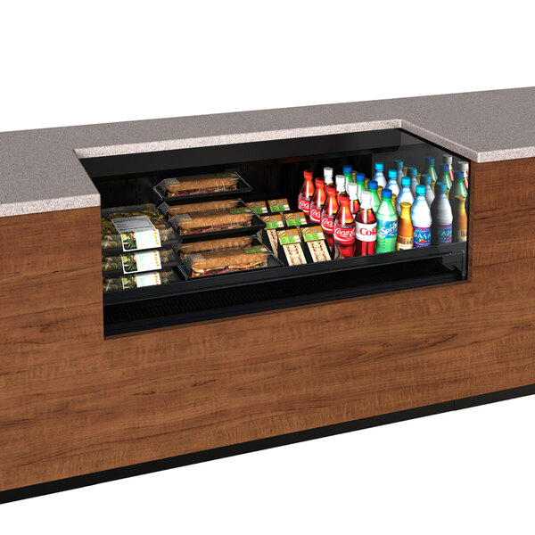 A Structural Concepts Oasis black undercounter air curtain merchandiser filled with food and drinks on a counter.