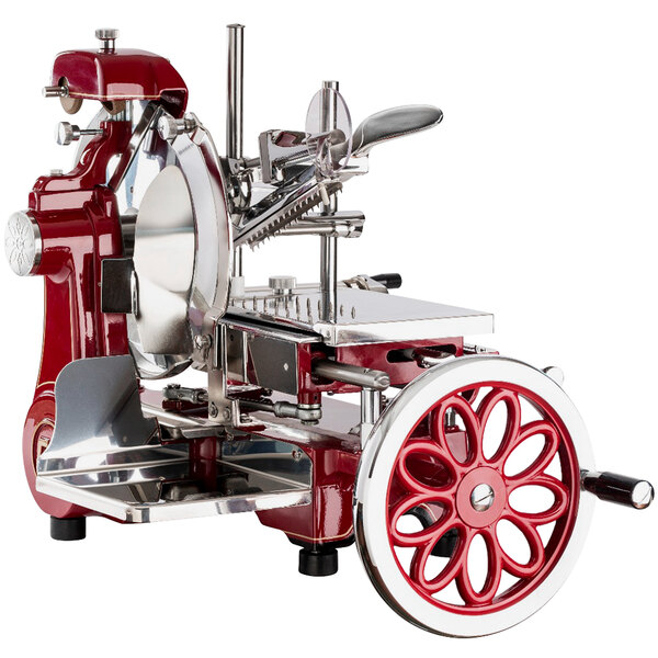 An Omcan red and silver manual meat slicer with standard flower flywheel.