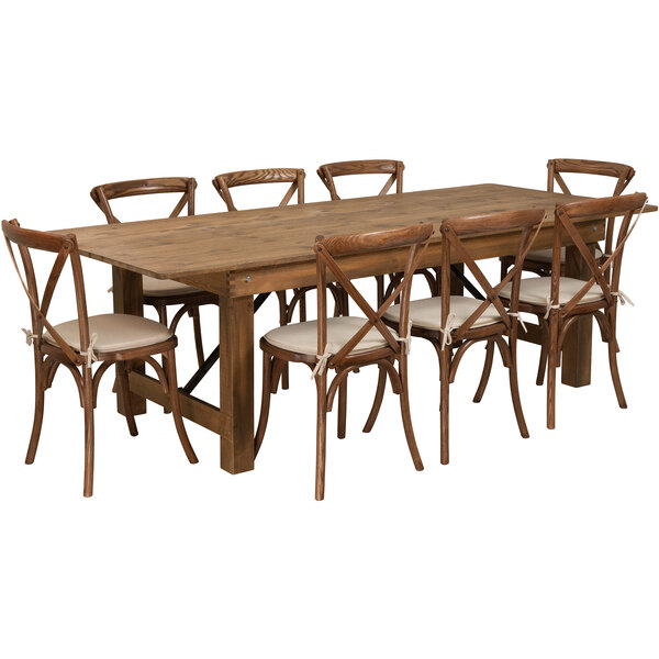 A Flash Furniture solid pine folding farm table and chairs with white cushions.