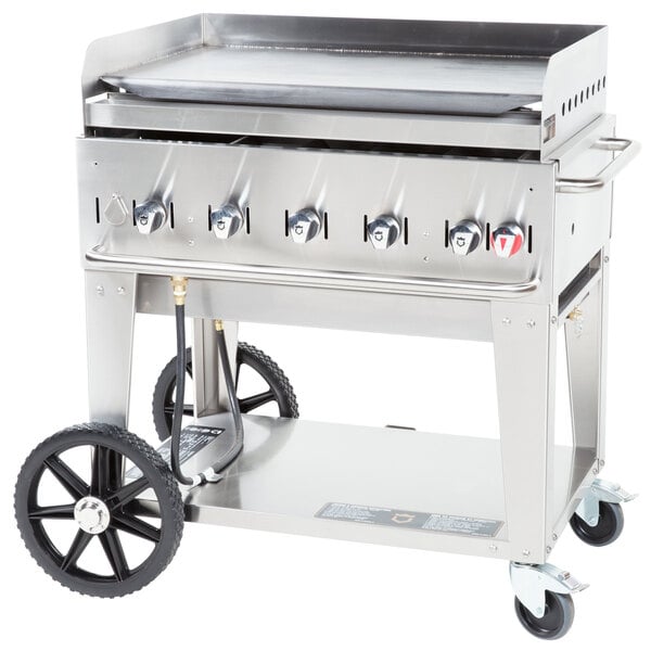 A stainless steel Crown Verity portable outdoor griddle on wheels with a black handle.