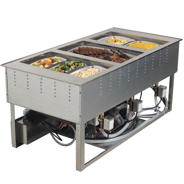 A Vollrath drop-in hot food well with trays of food inside.