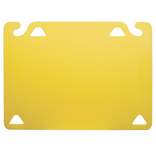 A yellow plastic cutting board with two holes.