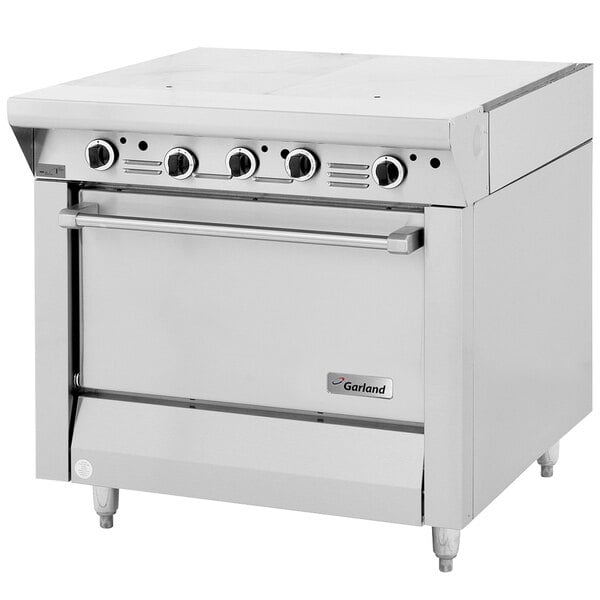 A white Garland commercial gas range with four knobs.