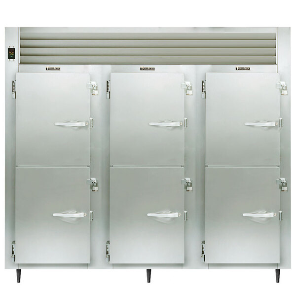 The open half door of a white Traulsen heated holding cabinet with a white handle.