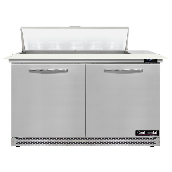 A stainless steel Continental Refrigerator with two doors open over a cutting top.