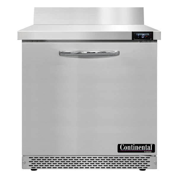 A Continental Refrigerator worktop freezer with the door open on a metal surface.