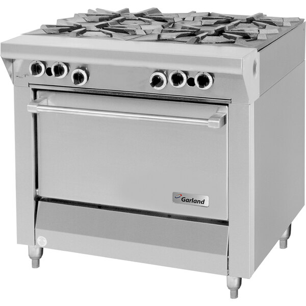 A U.S. Range stainless steel gas range with four burners.
