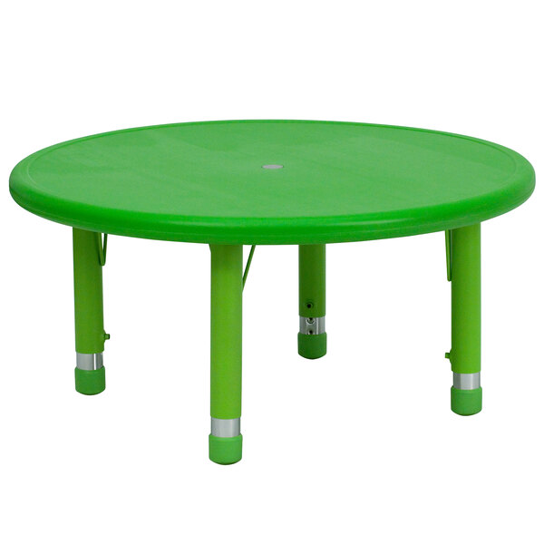 A green plastic Flash Furniture round table top with legs.