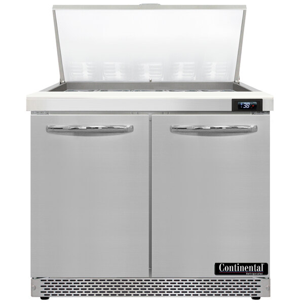A white Continental Refrigerator with two open doors over a counter.