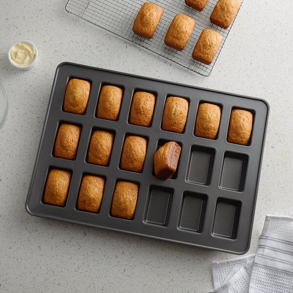 A Wilton mini loaf pan with baked mini loaves inside.