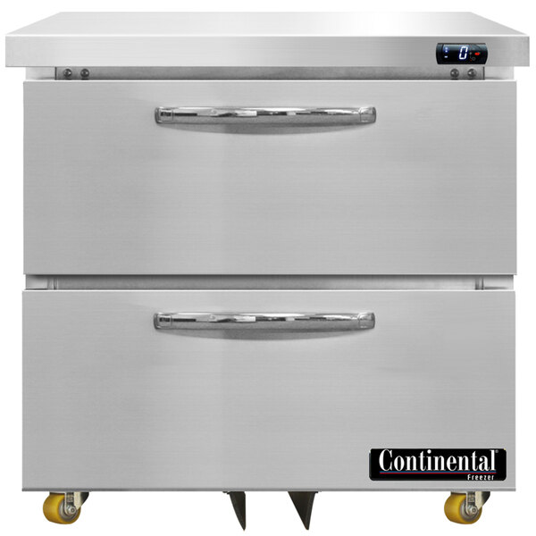 A Continental undercounter freezer with two white drawers and yellow wheels.