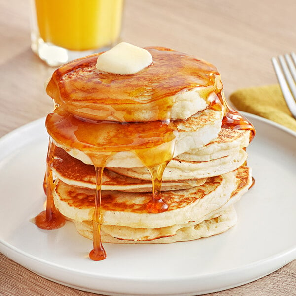 A stack of pancakes with butter and syrup on top.