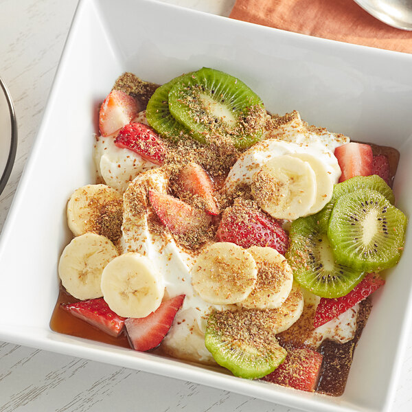 A bowl of fruit and granola with Bob's Red Mill Gluten-Free Ground Flaxseed Meal on top.