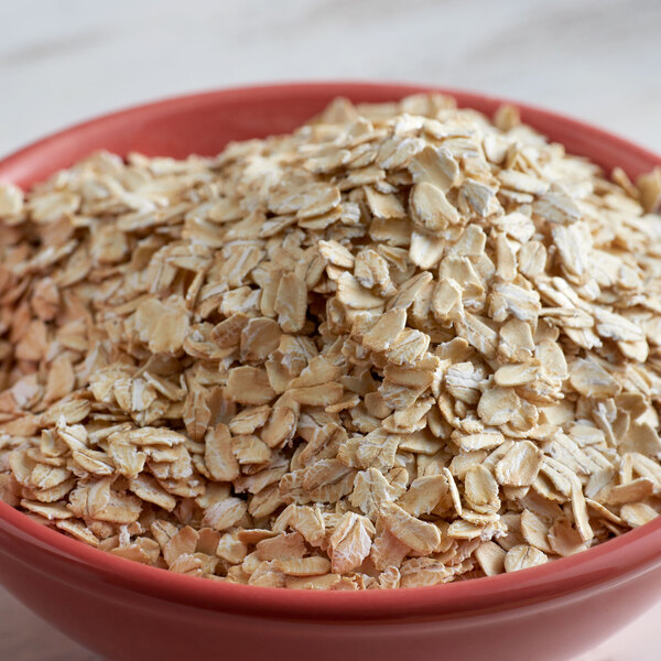 A bowl of Bob's Red Mill gluten-free oat flakes on a table.