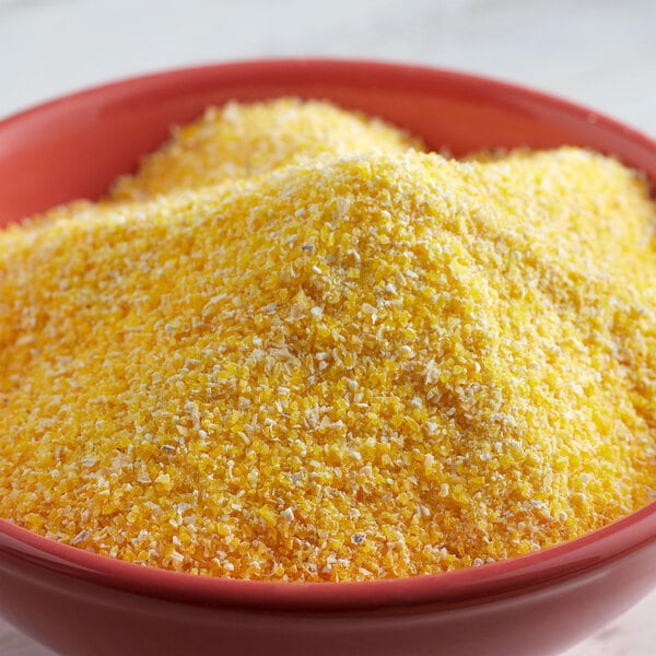 A bowl of Bob's Red Mill corn grits on a white table.