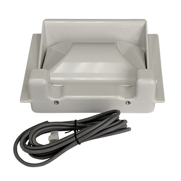 A grey plastic box with a cord attached.