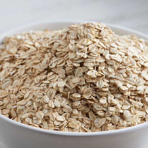 A bowl of Bob's Red Mill extra-thick whole grain rolled oats.
