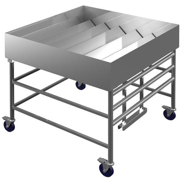 A Winholt stainless steel cold food display table on wheels with adjustable trays inside.