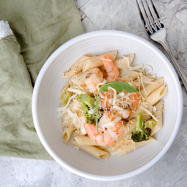 A bowl of Regal penne pasta with shrimp and broccoli.